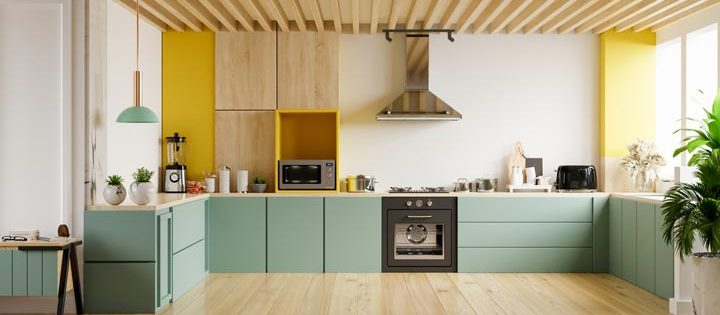 a modern kitchen with green cabinet, wooden wall and wooden flooring