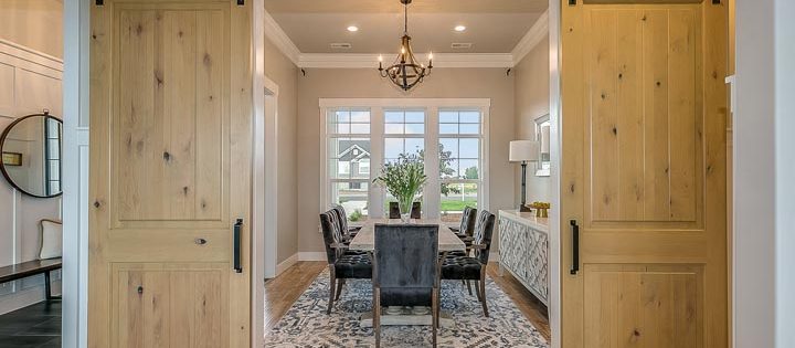 a luxury home office with wooden sliding doors and a beautiful window view