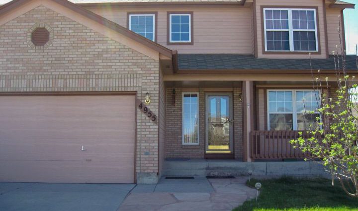 a beautiful house exterior with newly painted siding and window trims