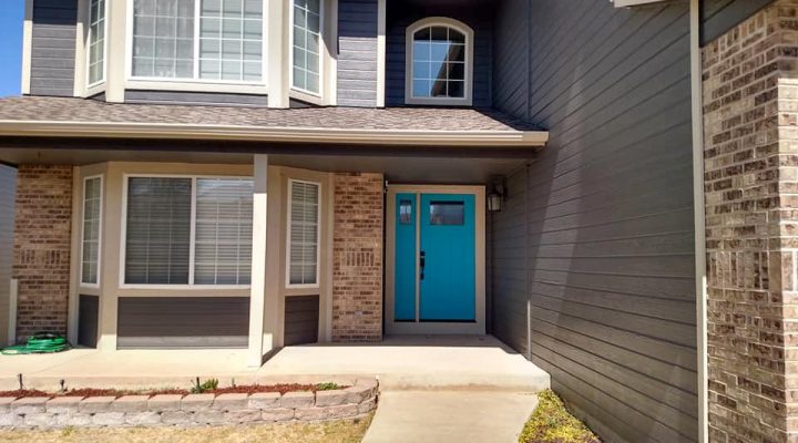 a two-story house with newly painted window trims and door