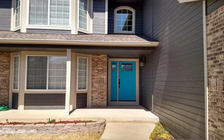 a two-story house with newly painted window trims and door