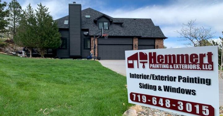 close up of the company signage on the lawn of a client's house at the background with newly painted siding and windows