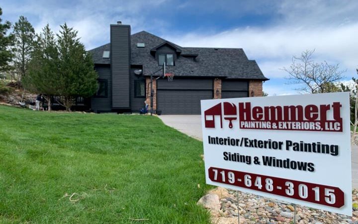 close up of the company signage on the lawn of a client's house at the background with newly painted siding and windows